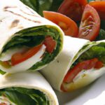 Fresh & Flavorful: Tomato Mozzarella Wrap with Zesty Pesto