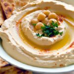 Dip into Delight: Creamy Hummus Paired with Crispy Pita Chips